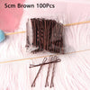 A bundle of 100 brown metal U-shaped hair pins is displayed on a pink surface.