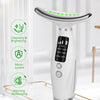 A white vibration face and neck massager device resting on a gold tray with green light accents.