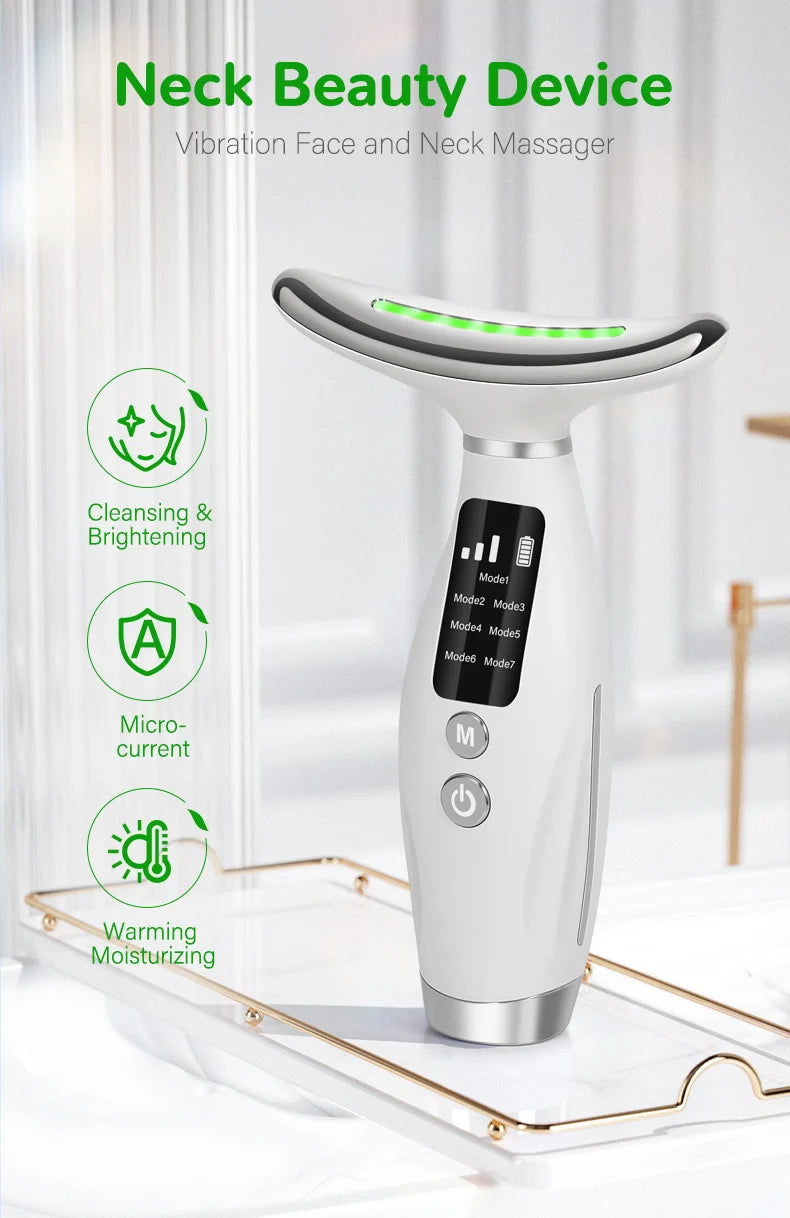 A white vibration face and neck massager device resting on a gold tray with green light accents.