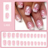 A set of press-on acrylic flower nails in various pink and white floral designs shown on fingers and swatches.