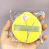 A yellow makeup puff set with a white tulip design is sealed in a clear plastic bag.