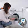 A woman is using an electric heated neck and shoulder massager on a white washing machine.