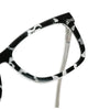 A close-up view of a black and white patterned anti-blue light eyewear frame with clips.
