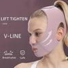 A woman is wearing a pink V-Line face slimming lifting bandage on her face.