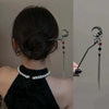 Primer plano del cabello oscuro de una mujer recogido en un moño, con horquillas para el cabello estilo mariposa vintage de a