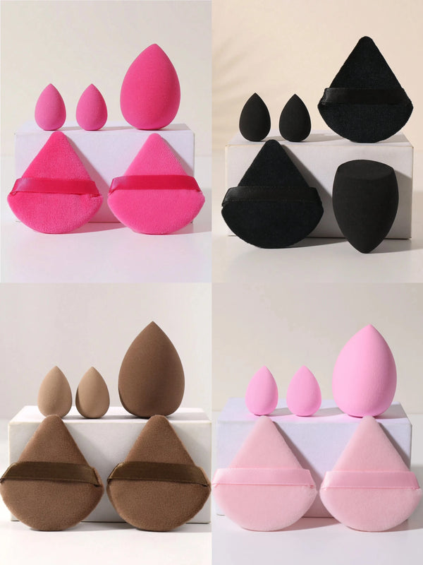 A set of five makeup sponge applicators in various shades of pink, black, and brown are displayed on white boxes.