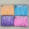 Un ensemble de ciseaux à sourcils de précision dans diverses couleurs, dont orange, bleu et violet.