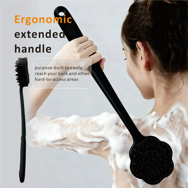 A woman is using a black long-handle silicone body brush with a dual-sided head on her arm.