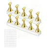 A set of gold-colored nail practice stands with double-sided tape arranged in a row on a clear plastic tray.