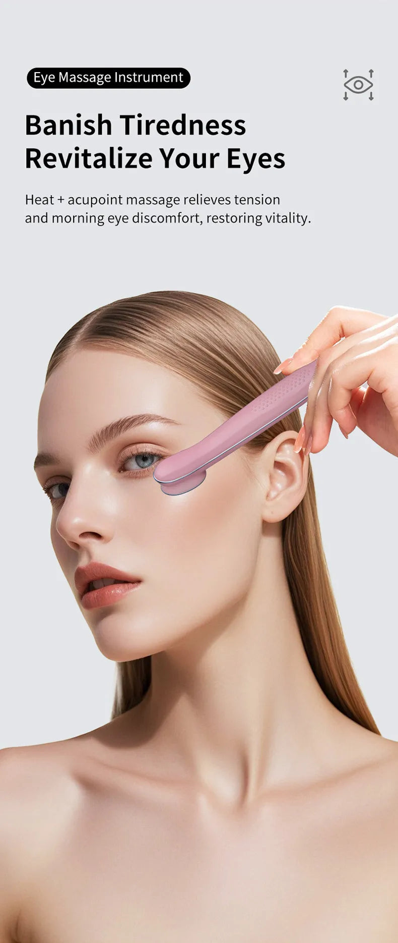 A woman is using a pink eye massage instrument on her eyelid to relieve tiredness and restore vitality.