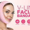 A woman is wearing a pink V-Line facial bandage strap on her face.