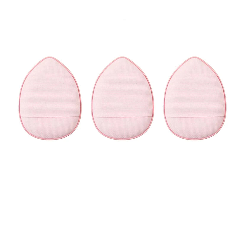 Three pink mini finger puff foundation applicator tools arranged horizontally.