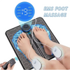 A person is using a portable EMS foot massager device to provide muscle relief and massage to their feet and legs.