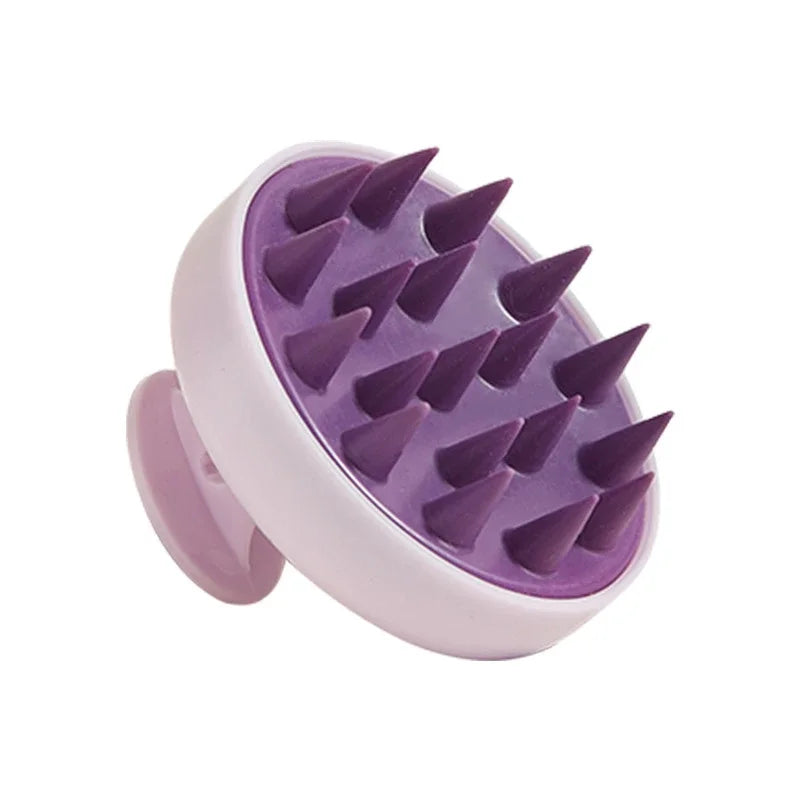 A purple silicone scalp massage and body brush with pink handles.