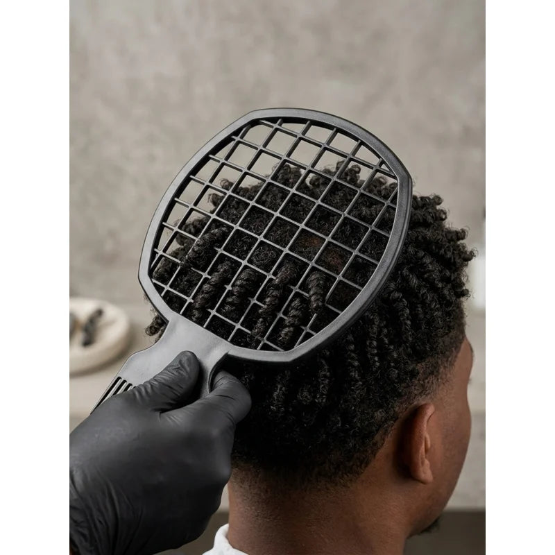 A hand is using a black premium African twist hair comb to style dreadlocks on a person's head.