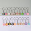 A set of 20 cartoon smile face keychains in various colors and shapes arranged in a single row.
