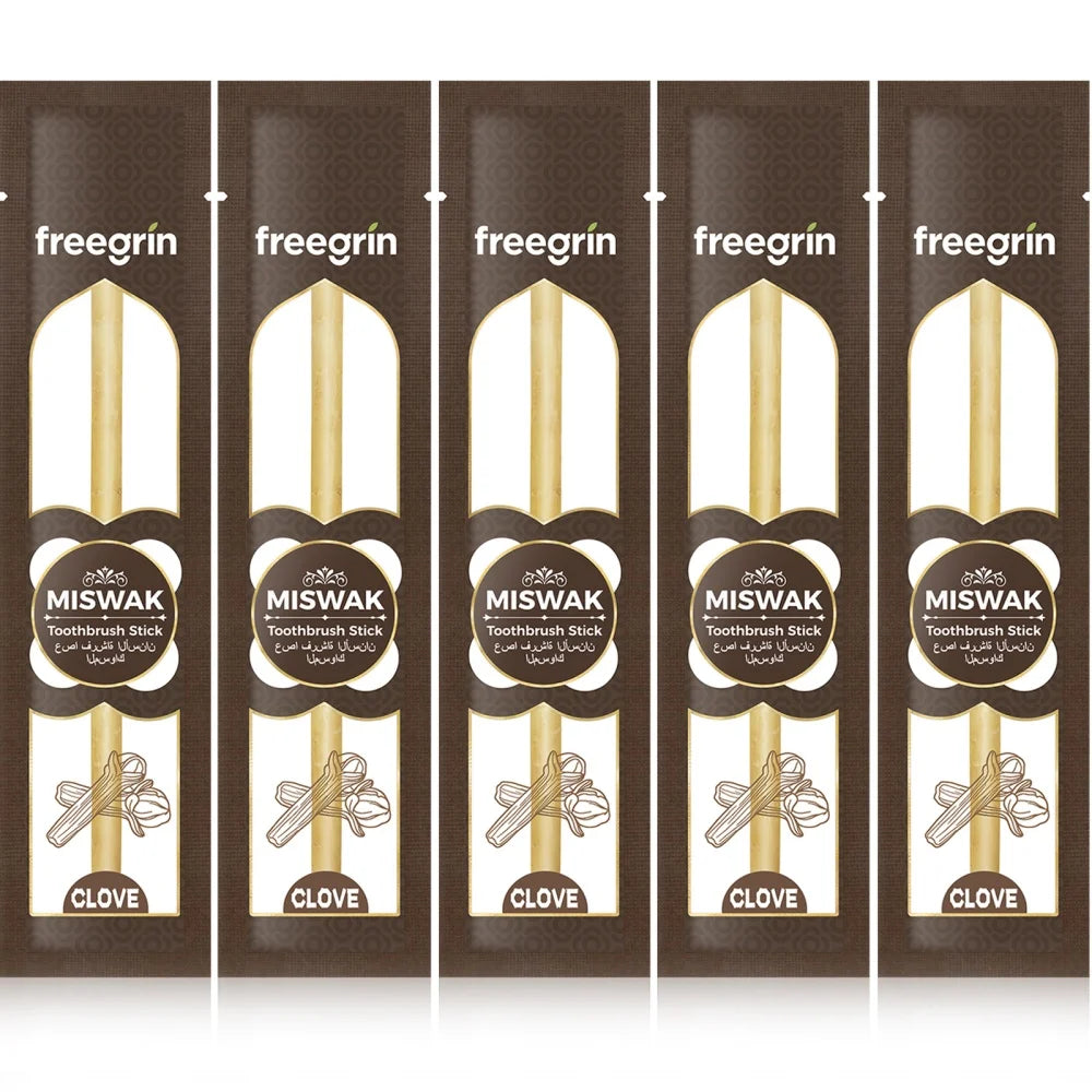 Five packaged Miswak toothbrush sticks labeled freegrin and clove