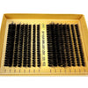 A gold tray holds numerous bundles of black eyelash extensions for DIY lash look.