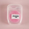 A spool of pink nylon dental floss is visible inside a clear plastic container.