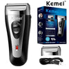 A black and silver Kemei professional electric shaver with a charging cable shown on a white background.