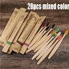 A collection of 20 mixed color eco-friendly bamboo toothbrushes displayed on a wooden surface.