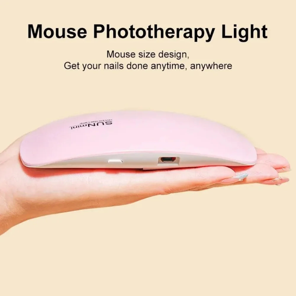 A hand holds a pink Sunmint mouse-shaped phototherapy light for nail treatment.