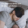 A man is sleeping with a dark eye mask on his face, demonstrating the product's fit.
