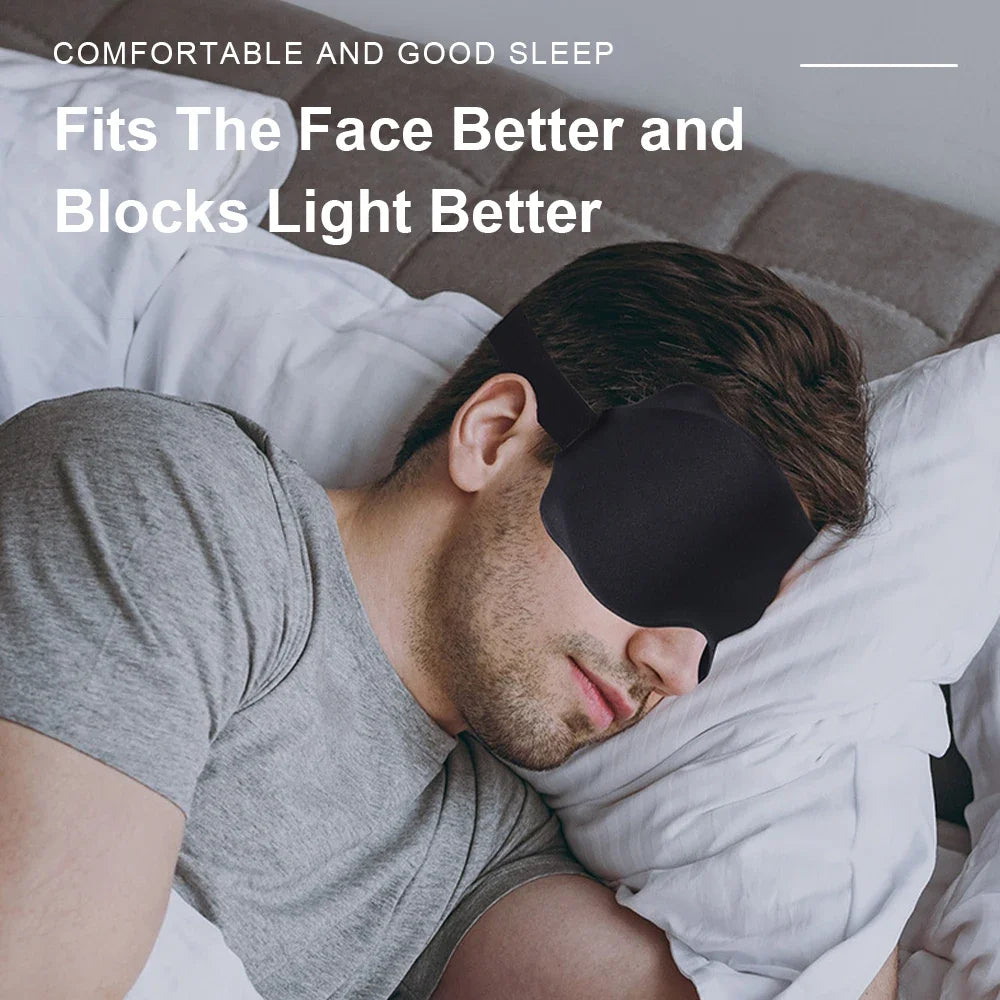 A man is sleeping with a dark eye mask on his face, demonstrating the product's fit.