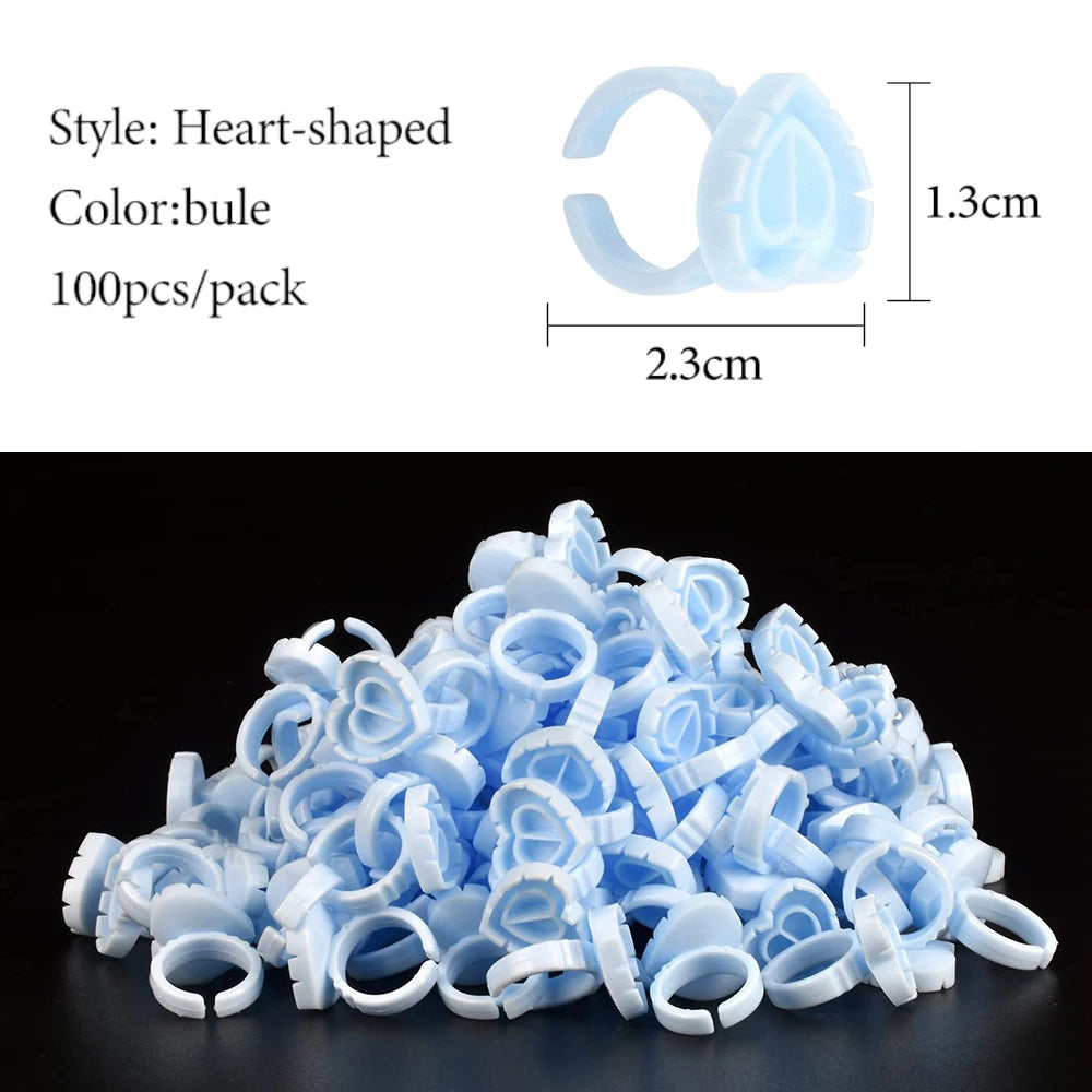 A pile of light blue heart-shaped disposable glue rings for eyelash extensions and nail art
