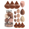A set of fifteen makeup sponges in various shades and shapes displayed next to a glass jar.
