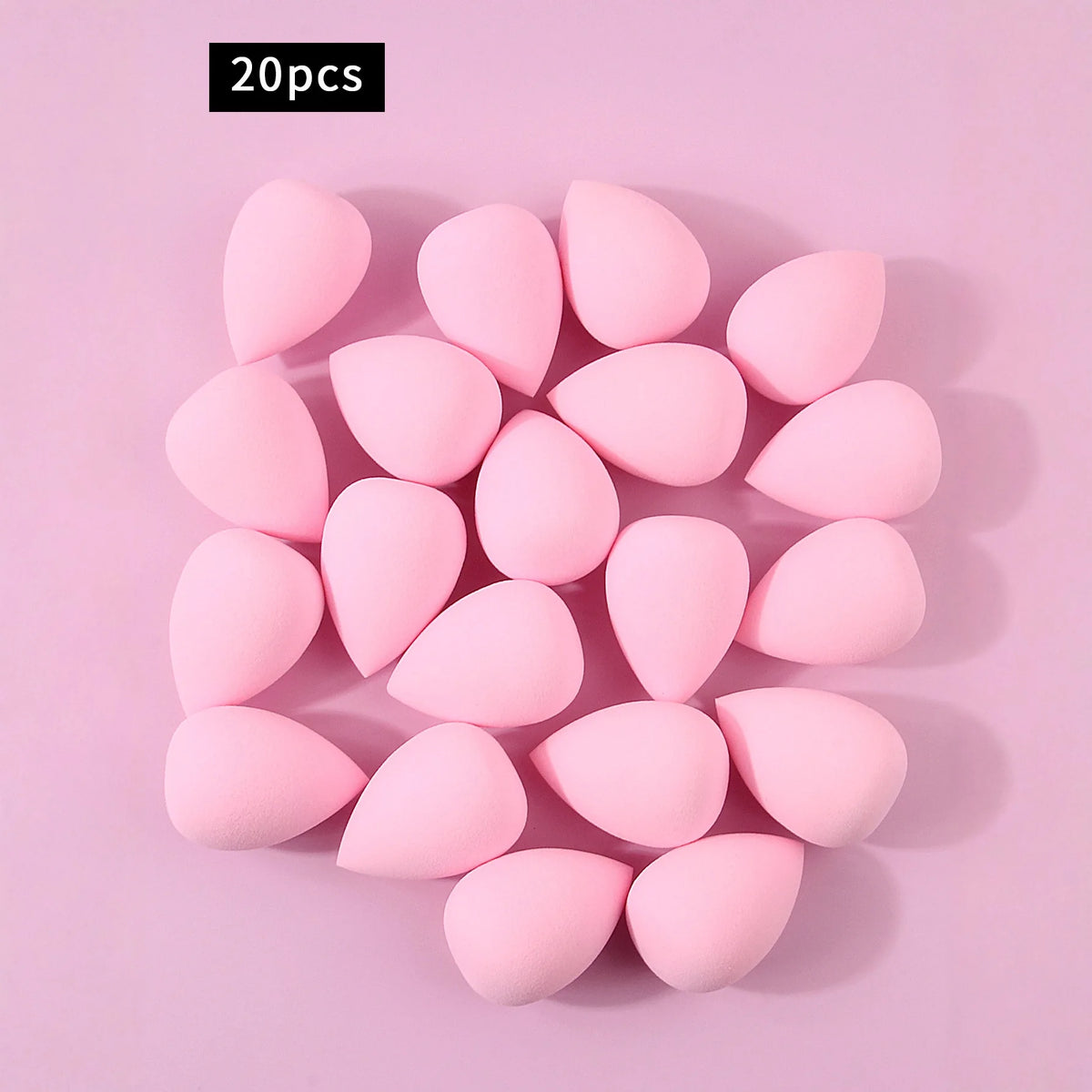A set of 20 pink, oval-shaped XL soft makeup sponges arranged on a light pink background.