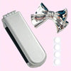 A silver portable compact comb with an airbag and mirror next to a shiny silver bow.
