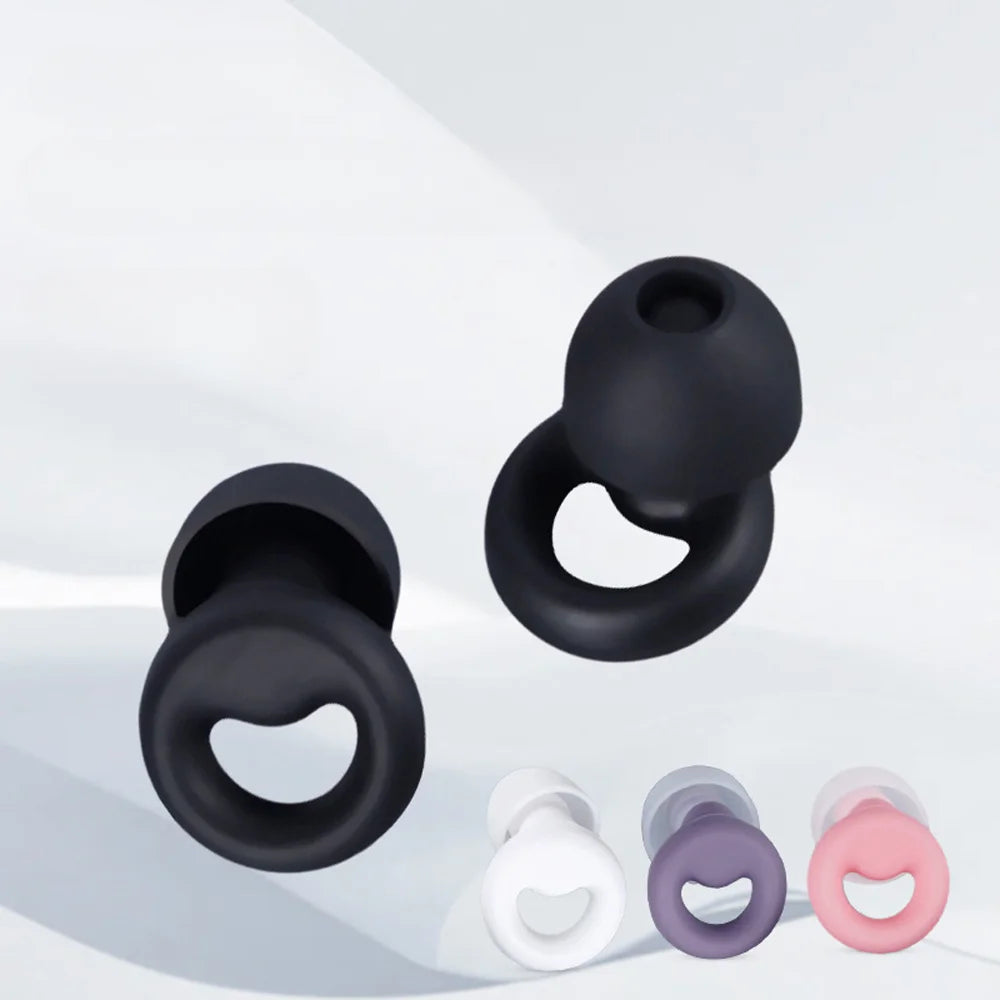 A collection of silicone earplugs in black, white, and pink are shown against a light background.