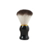 A professional shaving kit featuring a brush with dark brown and white bristles set in a black ceramic bowl and stand.