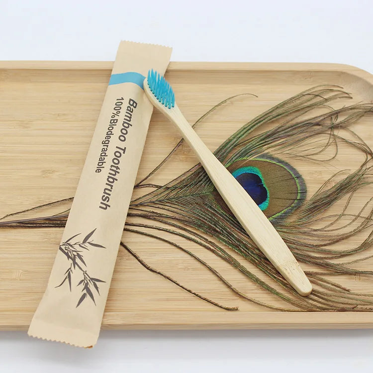 A bamboo toothbrush is shown next to a wooden cutting board with dried plant material.