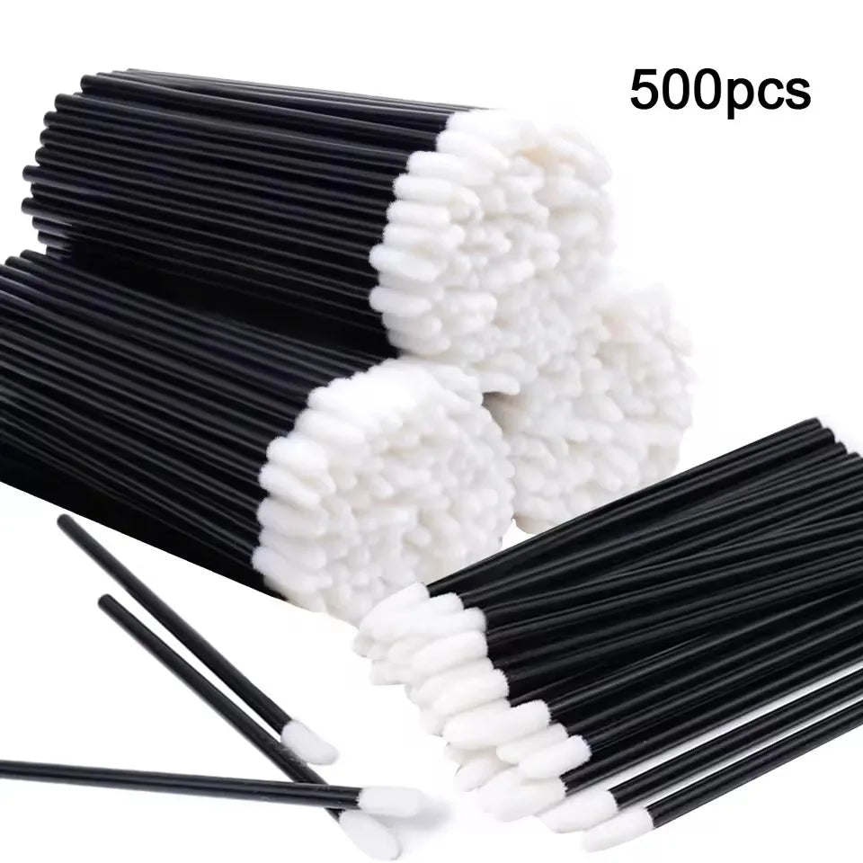 A bundle of 500 disposable black lip wands with white tips.