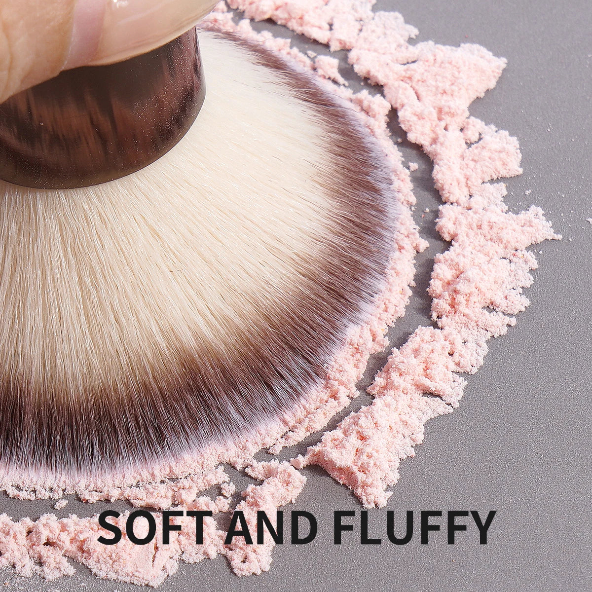 A close-up of a fluffy makeup brush with soft pink powder scattered around it, emphasizing a soft and fluffy texture.