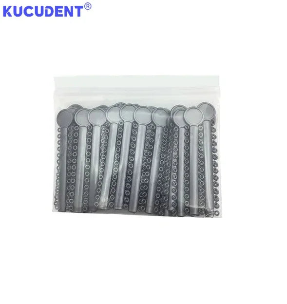 A clear plastic bag containing numerous silver orthodontic elastic ligature ties for braces.