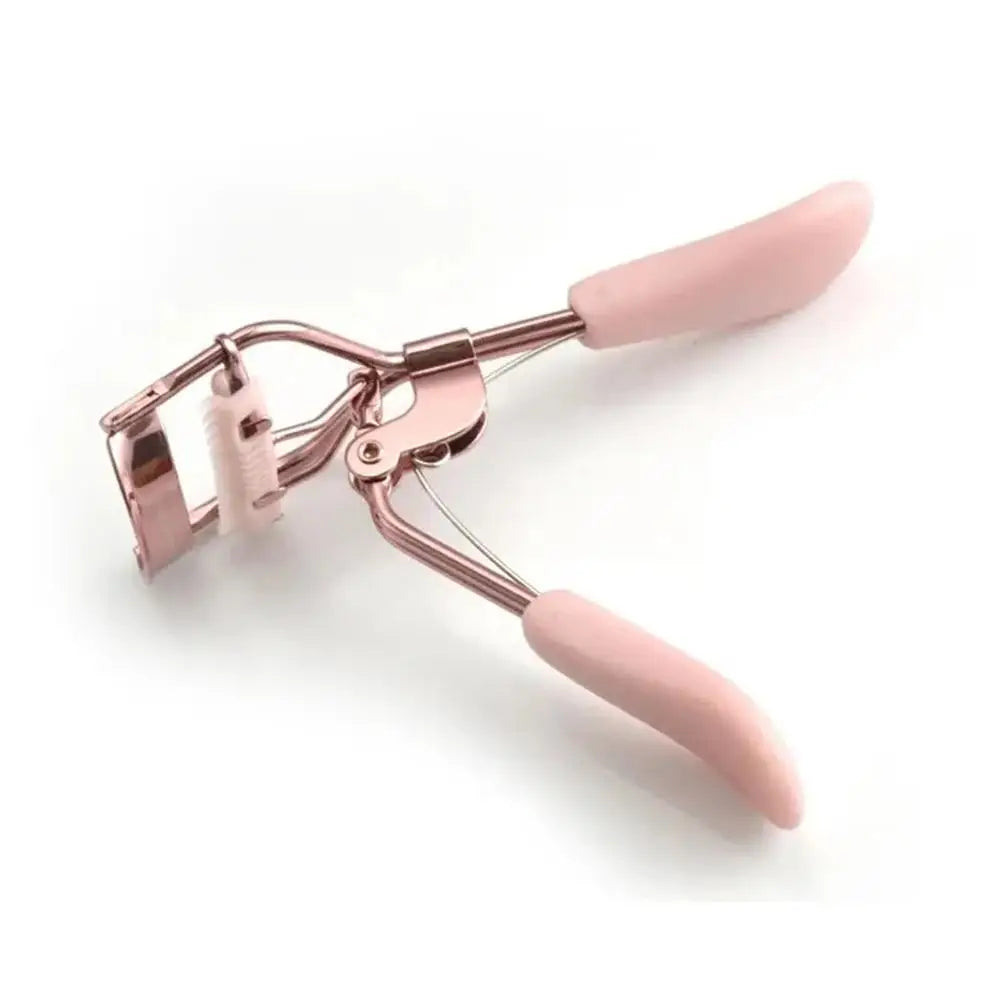 Un recourbe-cils rose professionnel avec un peigne, montré sur fond blanc.