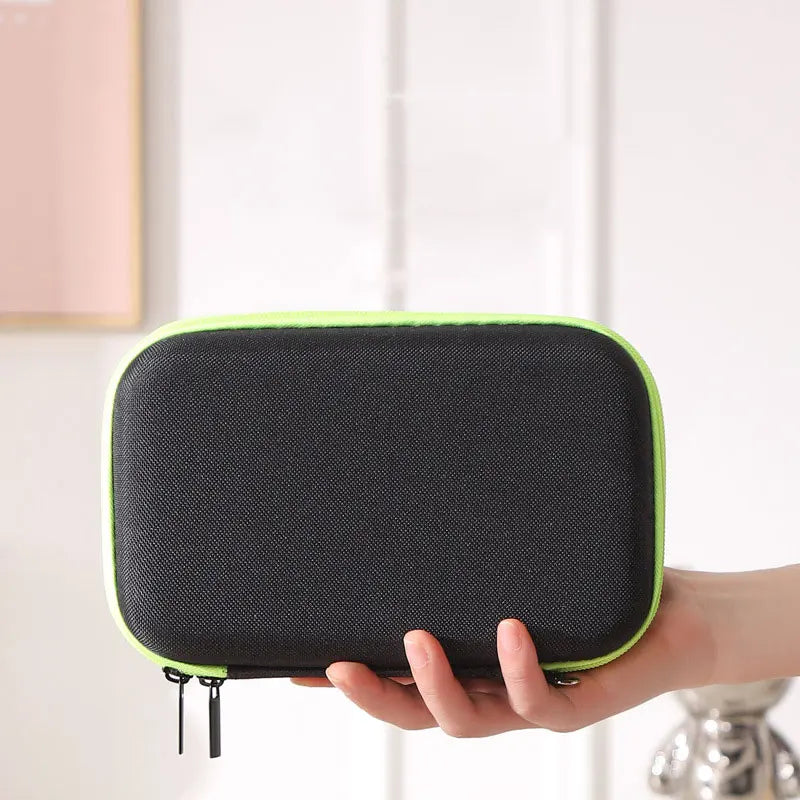 A hand holds a black hard-shell travel case with a lime green trim for electric shavers.