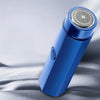 A blue portable electric shaver with a textured head is shown against a gray background.