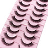 Un plateau rose contenant plusieurs paires de faux cils de renard noirs.