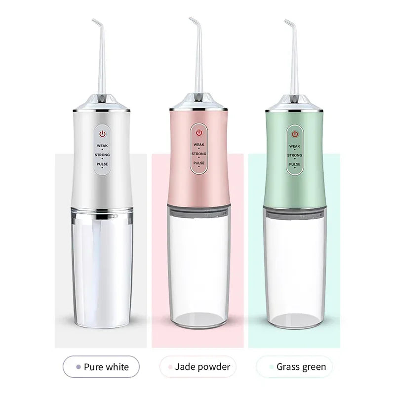 Three portable USB rechargeable water flossers in pure white, jade powder, and grass green colors shown side by side.
