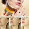 A woman is shown receiving a lymphatic contour facial massage using a golden brush on her face.