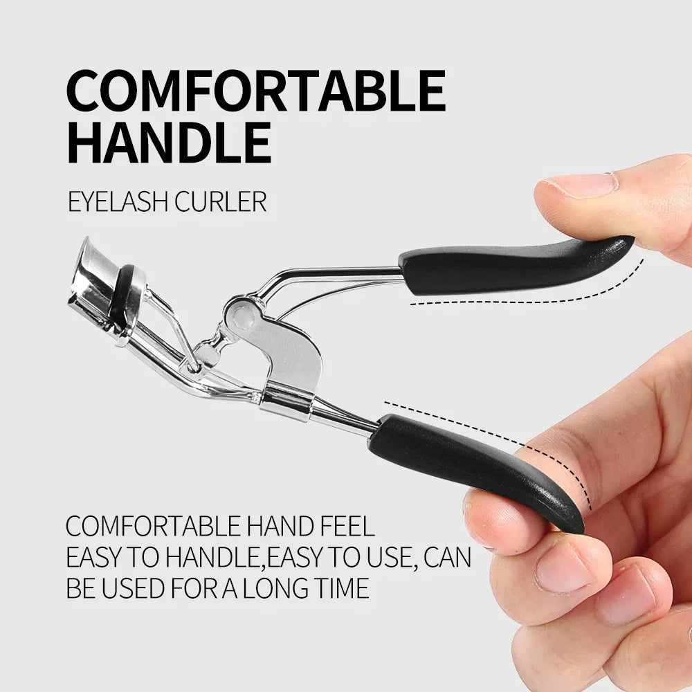 A close-up of a silver eyelash curler with a black handle being held by a hand.