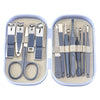 A stainless steel nail clipper set with various tools and scissors stored in a light blue plastic case.