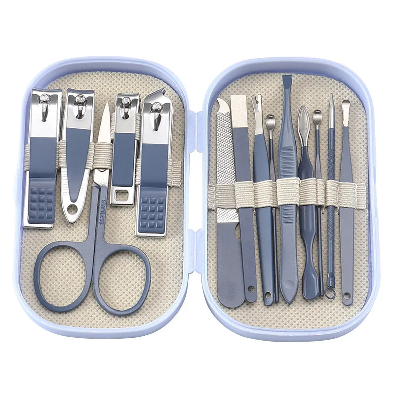 A stainless steel nail clipper set with various tools and scissors stored in a light blue plastic case.