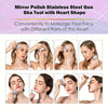 Stainless steel Gua Sha tool with a heart shape used to massage the face.