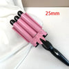 A pink professional triple barrel ceramic hair curling iron with a black handle, shown against a white background.