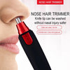 A close-up of a red and black nose hair trimmer device being used on a person's nose.